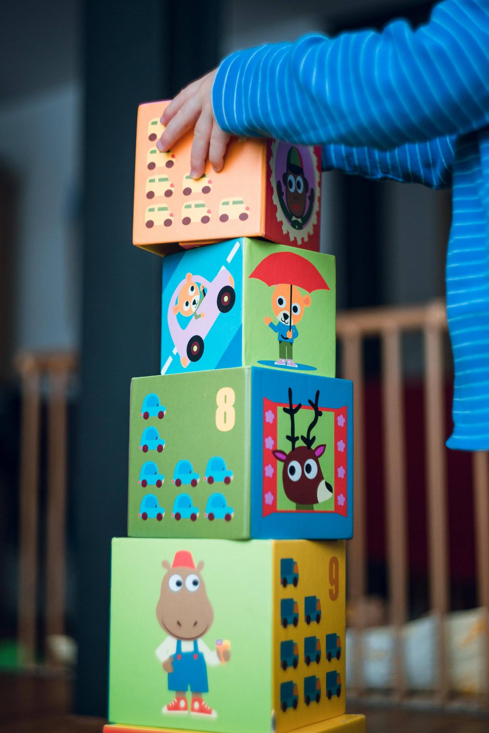A child stacking picture blocks into a tower