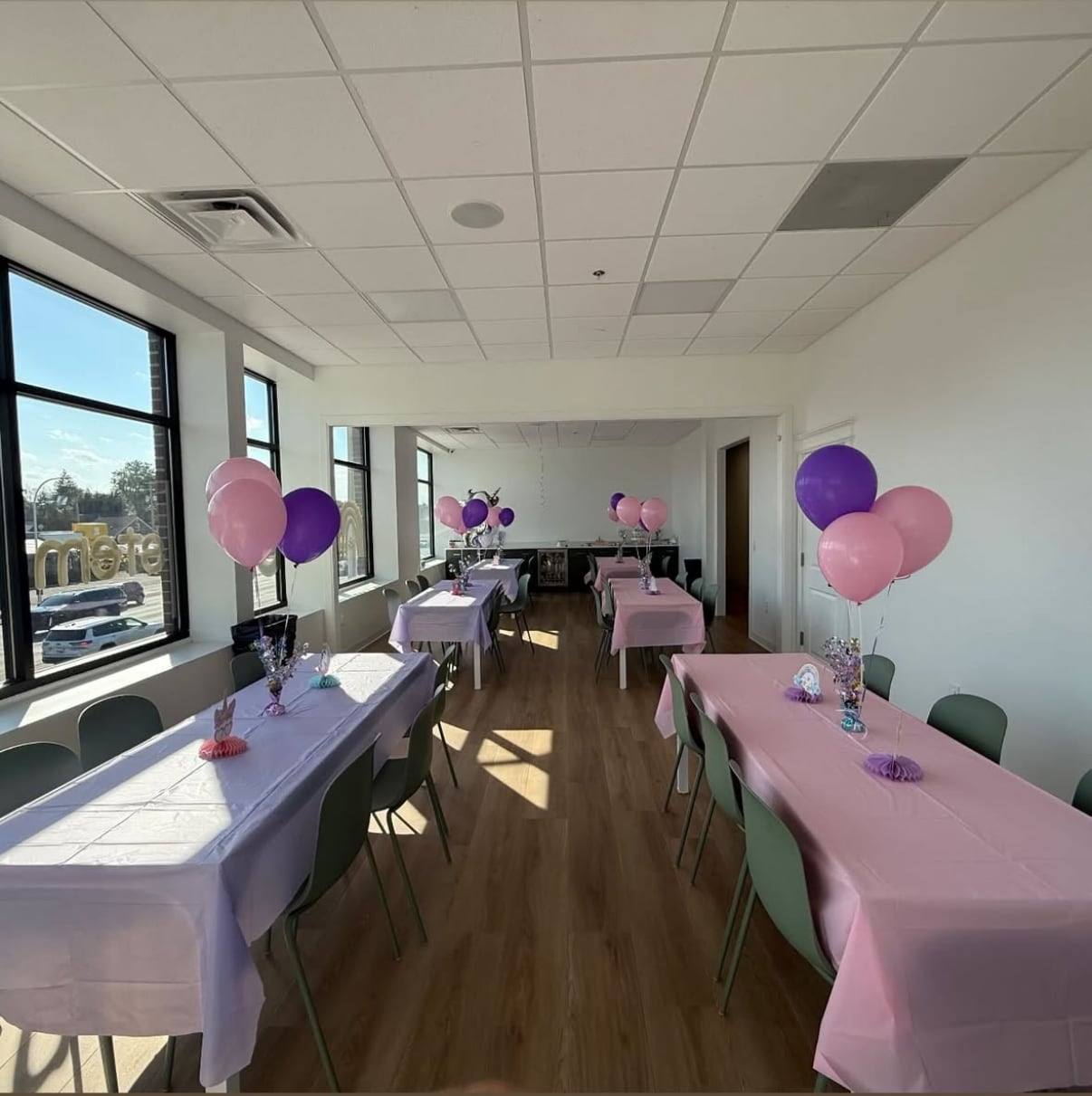 The party room at Bloom set with pink tablecloths and balloons