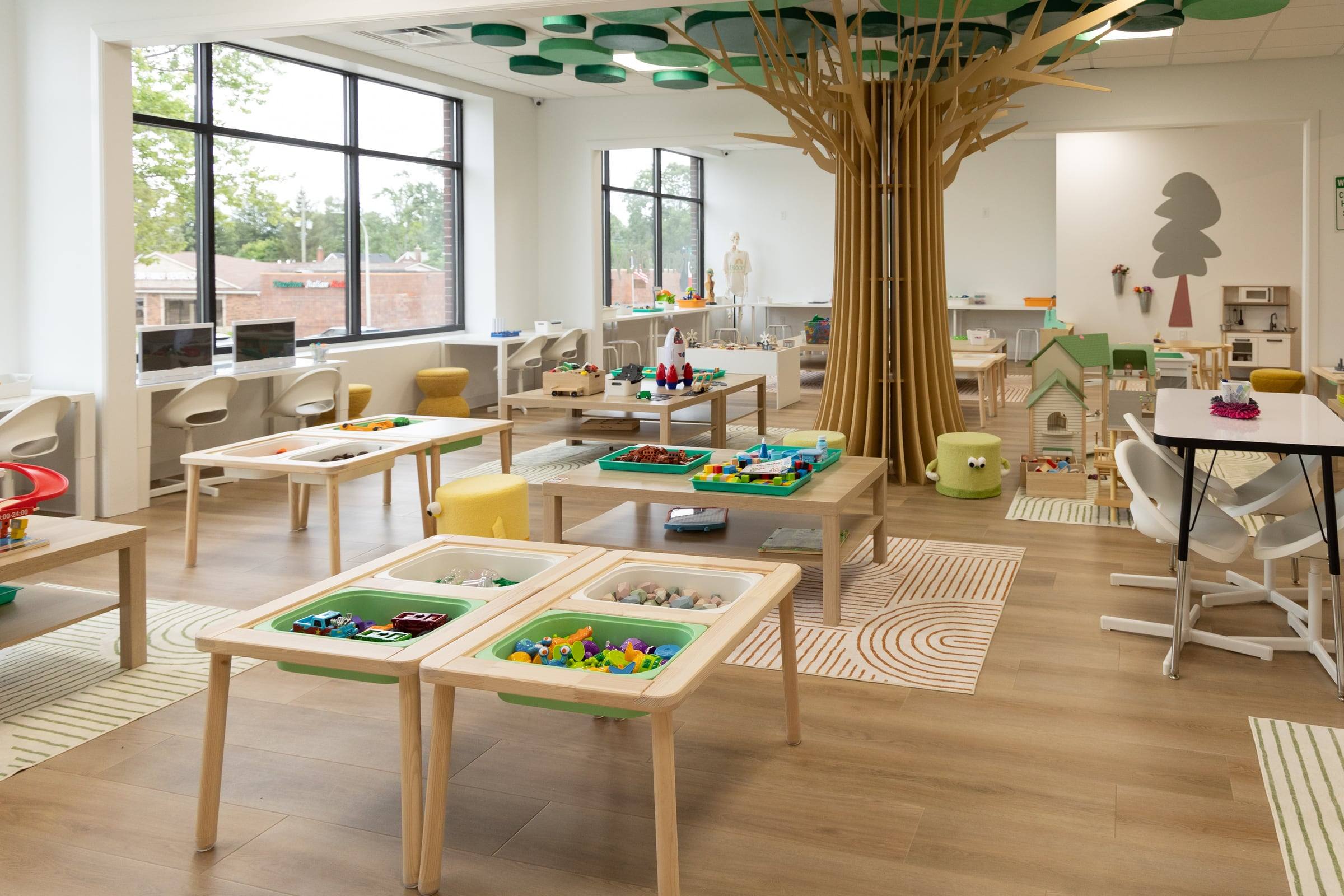 Play tables with building sets and the wooden tree